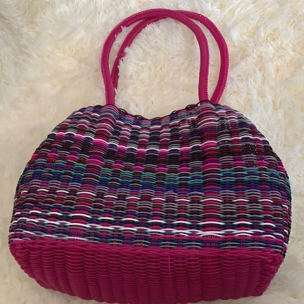 Handwoven plastic bag in multicolor with pink bottom and pink handles